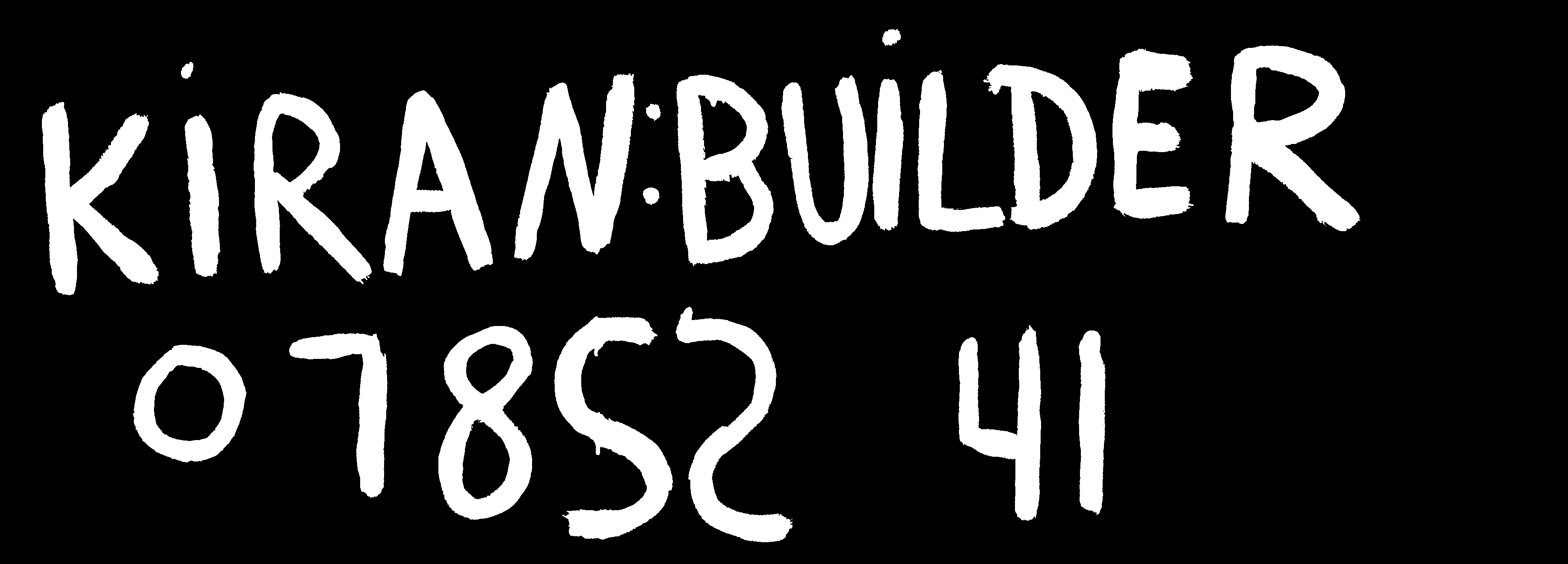 Black and white picture of writing on wall that says "Kiran: Builder" and a phone number